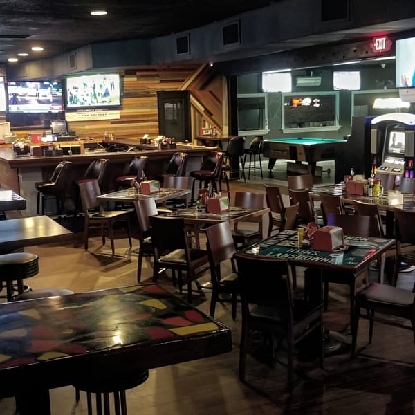 Interior of Nice N Easy Oyster Bar & Grille with a bar, dining tables, and a pool table.