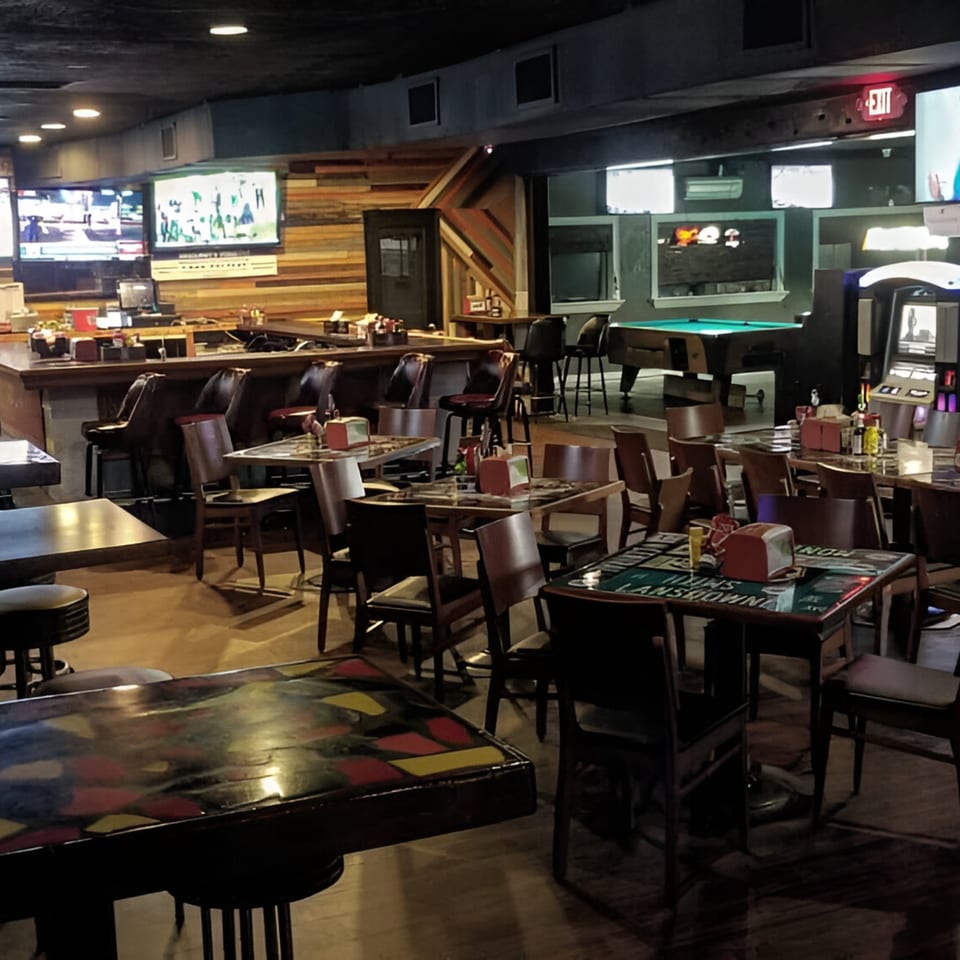 Interior of Nice N Easy Oyster Bar & Grille with a bar, dining tables, and a pool table.